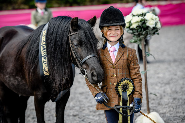 little girl smiling with her champion Shetland pony 
